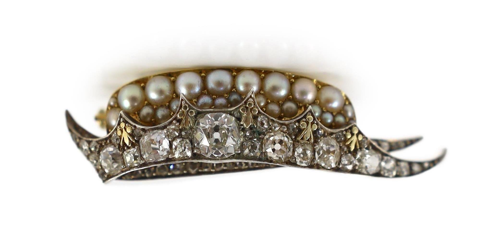 A Victorian gold and silver, diamond and split pearl set brooch, modelled as a 'chapeau gules turned up ermine' or heraldic cap of maintenance